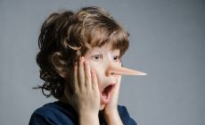 Boy in shock as his nose has grown like Pinocchio's
